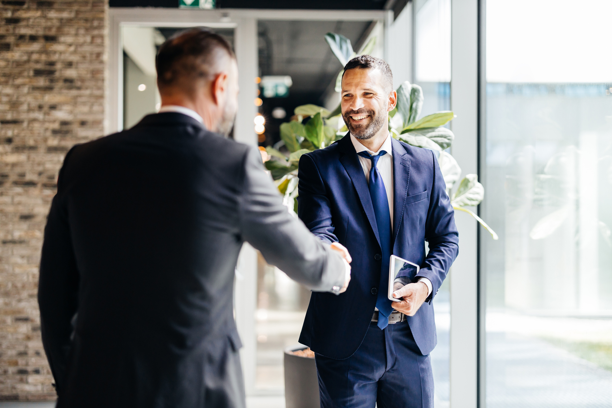 Business Handshake Greeting In A Bright Office